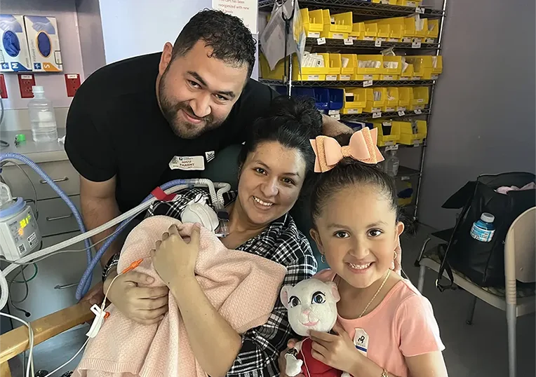 A baby and her family in a hospital